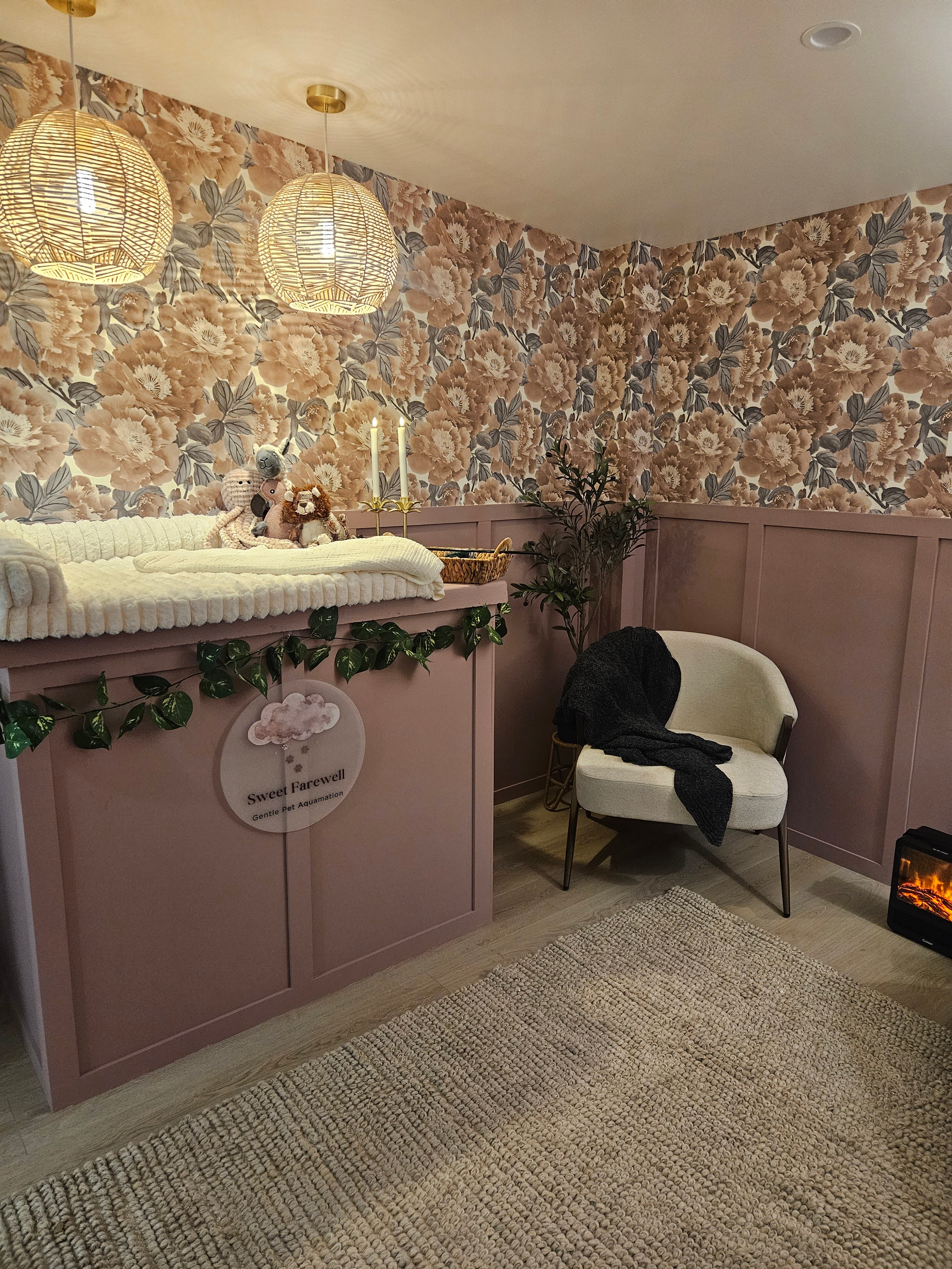The softly lit FAREWELL Room with floral wallpaper and comfortable seating